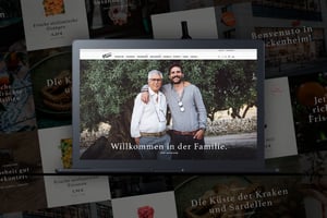 Screenshot einer Viani-Seite: Zwei Männer stehen vor einem Olivenbaum, der ältere trägt eine Brille und eine Kamera um den Hals, der jüngere hat einen Bart und ein graues Hemd, darunter steht der Text ‚Willkommen in der Familie‘